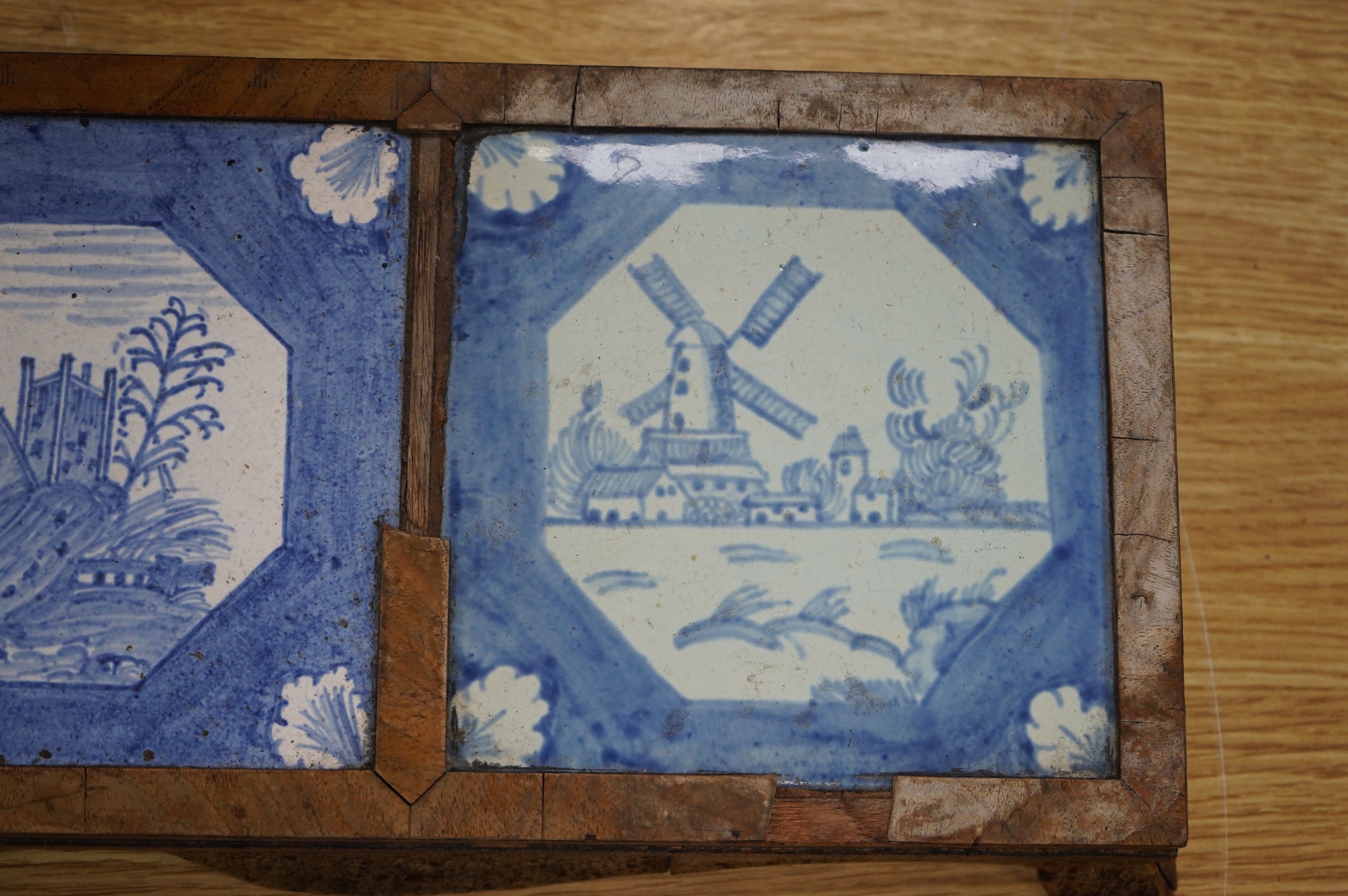 A 19th century Delft tile inset walnut stand, 49cm wide. Condition - poor